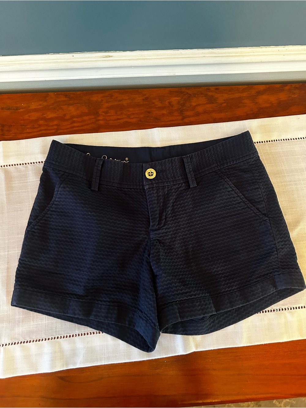 Lily Pulitzer Callahan shorts featuring a textured navy fabric and a gold button